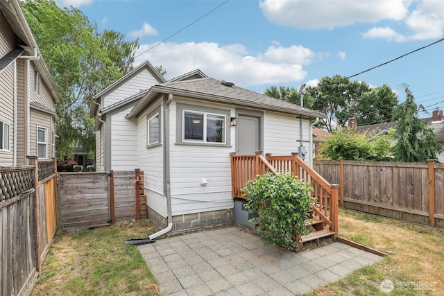 1022 N Anderson St, Tacoma, WA 98406 - back of house featuring a fenced backyard, a shingled roof, and a patio