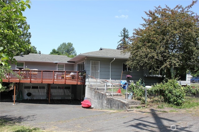 418 SW Canyon Loop, Winlock, WA 98596 - view of front of home featuring a deck, roof with shingles, and driveway