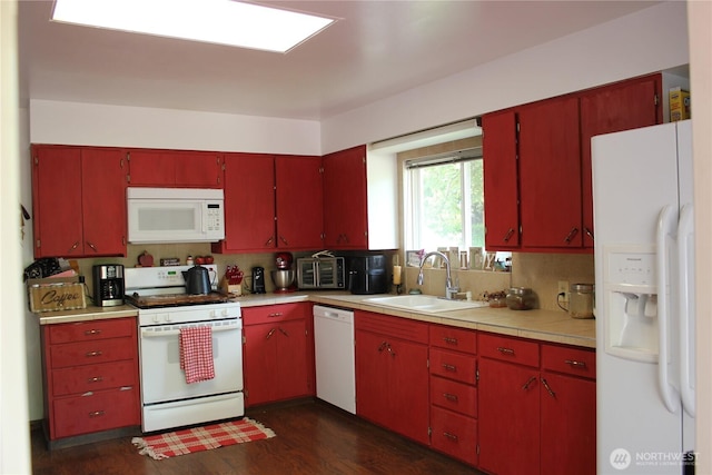418 SW Canyon Loop, Winlock, WA 98596 - kitchen with white appliances, a sink, red cabinetry, dark wood finished floors, and backsplash