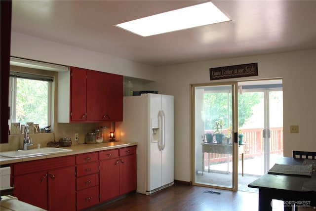 418 SW Canyon Loop, Winlock, WA 98596 - kitchen with a sink, light countertops, white refrigerator with ice dispenser, dark wood-type flooring, and decorative backsplash