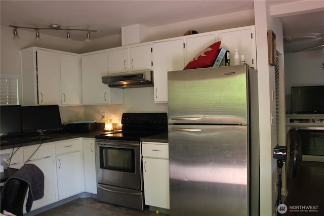 418 SW Canyon Loop, Winlock, WA 98596 - kitchen featuring stainless steel appliances, under cabinet range hood, dark countertops, and white cabinetry