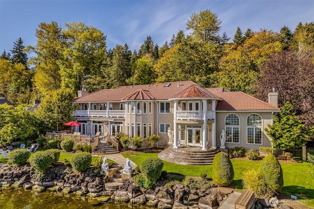 17765 Beach Dr NE, Lake Forest Park, WA 98155 - back of property featuring a balcony, french doors, a yard, a tile roof, and a chimney