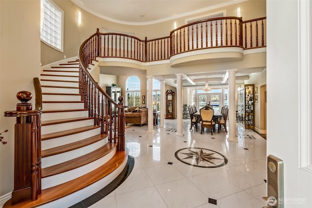 17765 Beach Dr NE, Lake Forest Park, WA 98155 - foyer entrance featuring ornate columns, crown molding, stairway, and tile patterned floors