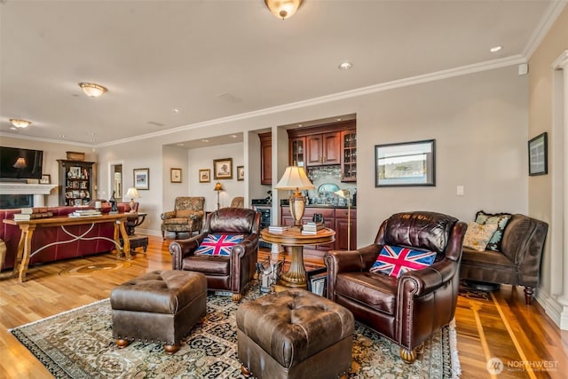 17765 Beach Dr NE, Lake Forest Park, WA 98155 - living room with wood finished floors, ornamental molding, recessed lighting, baseboards, and a tile fireplace