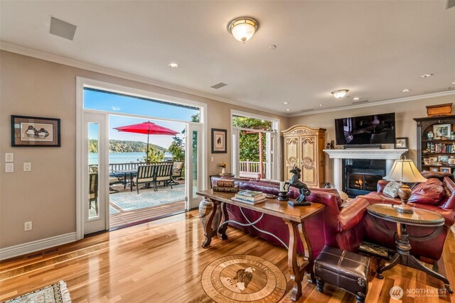 17765 Beach Dr NE, Lake Forest Park, WA 98155 - living area with a glass covered fireplace, light wood-style floors, ornamental molding, recessed lighting, and baseboards