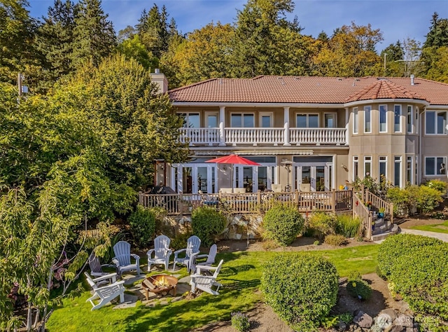 17765 Beach Dr NE, Lake Forest Park, WA 98155 - rear view of property with a balcony, an outdoor fire pit, a tile roof, a chimney, and a wooden deck