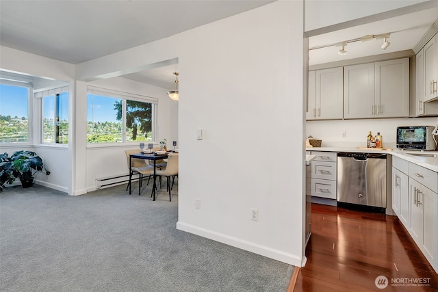 3814 11th Ave W Apt 23, Seattle, WA 98119 - kitchen with dishwasher, light countertops, baseboards, baseboard heating, and track lighting