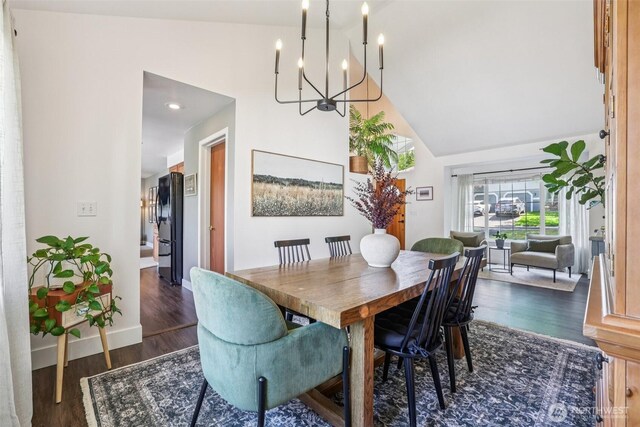 26820 NE 163rd St, Duvall, WA 98019 - dining room with a chandelier, dark wood-style flooring, high vaulted ceiling, and baseboards