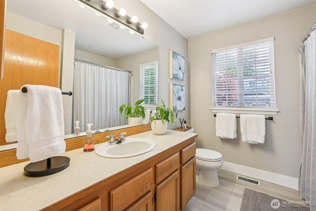 26820 NE 163rd St, Duvall, WA 98019 - full bath with vanity, toilet, healthy amount of natural light, and baseboards