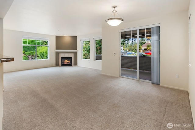 2220 132nd Ave SE Unit A220, Bellevue, WA 98005 - unfurnished living room with carpet flooring, a tiled fireplace, and baseboards