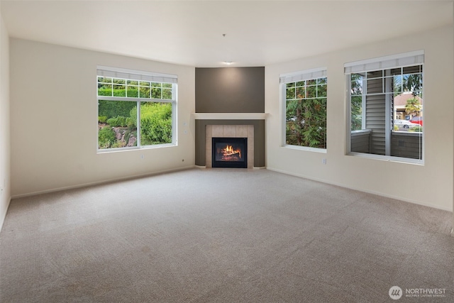 2220 132nd Ave SE Unit A220, Bellevue, WA 98005 - unfurnished living room featuring carpet, a tiled fireplace, and baseboards