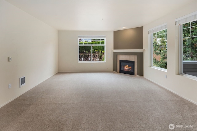 2220 132nd Ave SE Unit A220, Bellevue, WA 98005 - unfurnished living room with a tiled fireplace, carpet, and baseboards