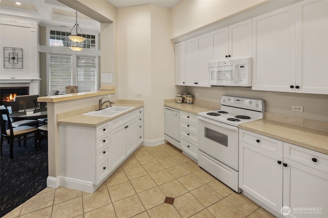 2220 132nd Ave SE Unit A220, Bellevue, WA 98005 - kitchen featuring white appliances, a sink, a peninsula, light tile patterned floors, and white cabinetry