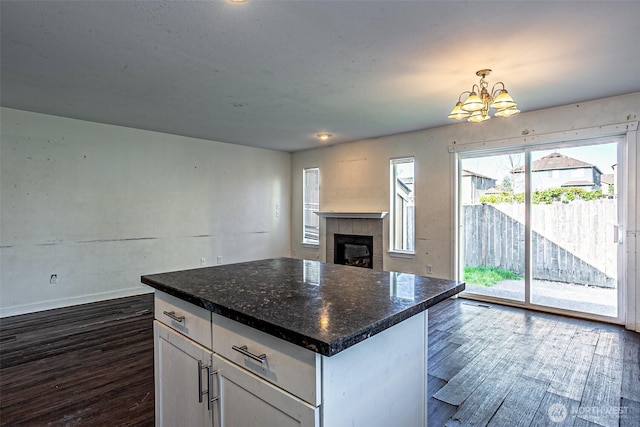 20007 17th Ave E, Spanaway, WA 98387 - kitchen featuring a chandelier, dark wood finished floors, open floor plan, white cabinets, and a fireplace