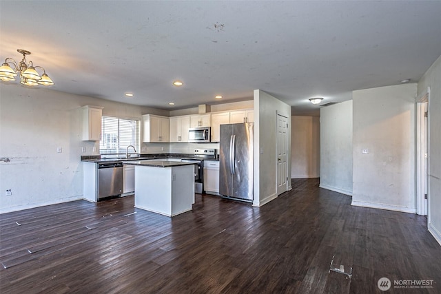 20007 17th Ave E, Spanaway, WA 98387 - kitchen featuring appliances with stainless steel finishes, a chandelier, dark wood finished floors, a sink, and recessed lighting