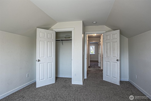 20007 17th Ave E, Spanaway, WA 98387 - unfurnished bedroom featuring dark colored carpet, lofted ceiling, a closet, and baseboards