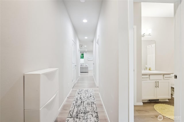 4305 23rd Ct NE, Olympia, WA 98516 - hallway featuring light wood-type flooring, recessed lighting, and a sink