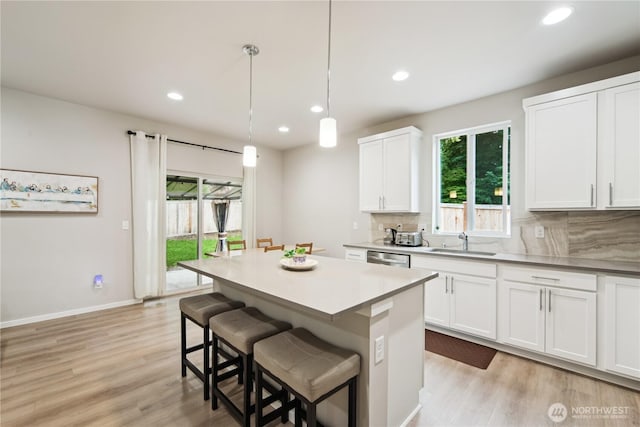 4305 23rd Ct NE, Olympia, WA 98516 - kitchen featuring a sink, light wood-type flooring, tasteful backsplash, recessed lighting, and white cabinetry