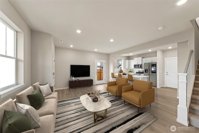 14830 203rd Ave E Unit 684, Bonney Lake, WA 98391 - living area with stairway, light wood-style floors, recessed lighting, and baseboards