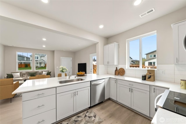 14830 203rd Ave E Unit 684, Bonney Lake, WA 98391 - kitchen with stainless steel dishwasher, open floor plan, a peninsula, a sink, and recessed lighting