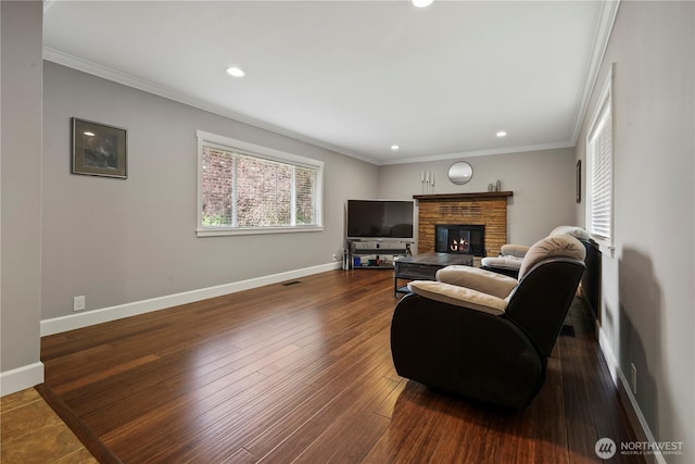11012 36th St E, Edgewood, WA 98372 - living room featuring ornamental molding, recessed lighting, a stone fireplace, and dark wood finished floors