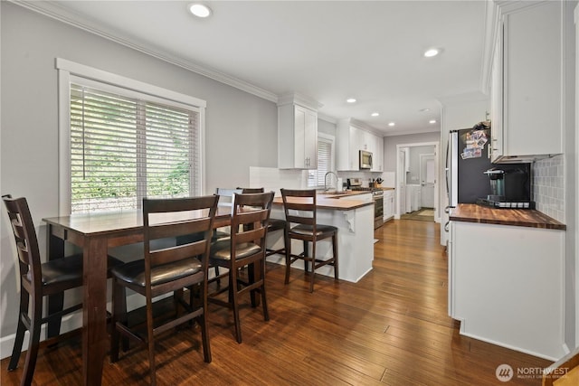 11012 36th St E, Edgewood, WA 98372 - dining space featuring ornamental molding, recessed lighting, and dark wood finished floors