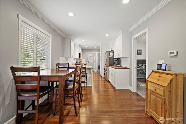 11012 36th St E, Edgewood, WA 98372 - dining space with ornamental molding, dark wood-type flooring, and recessed lighting