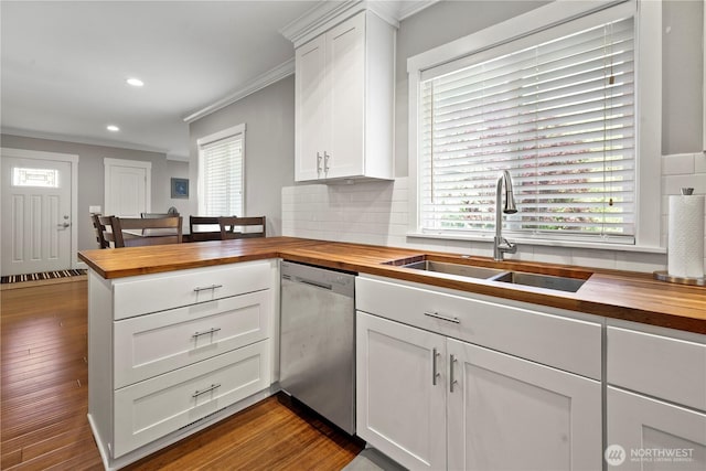 11012 36th St E, Edgewood, WA 98372 - kitchen featuring wood counters, stainless steel dishwasher, crown molding, a peninsula, and backsplash