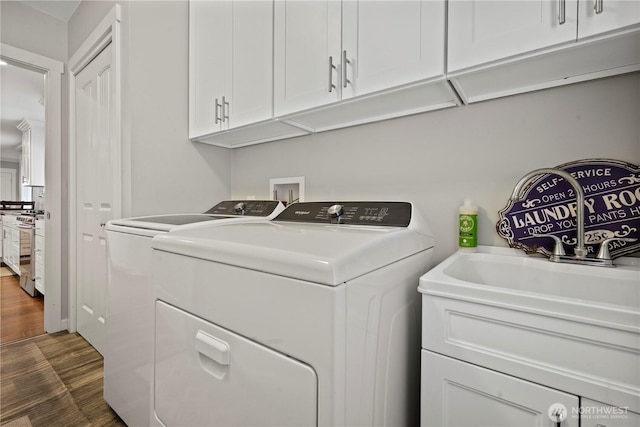 11012 36th St E, Edgewood, WA 98372 - laundry room with separate washer and dryer, dark wood-type flooring, and cabinet space