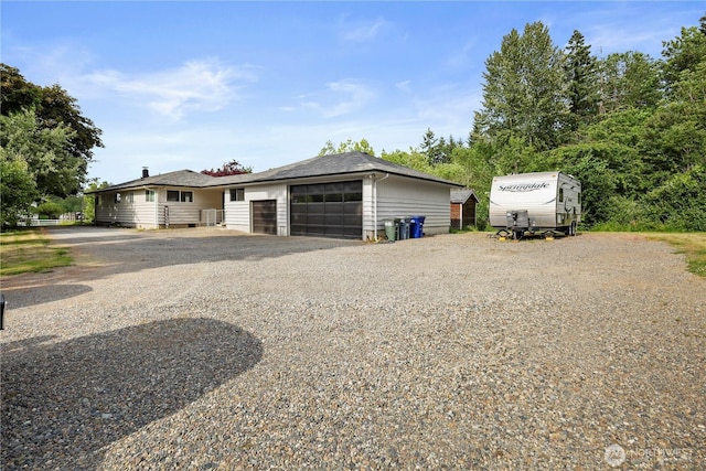 11012 36th St E, Edgewood, WA 98372 - view of front of home featuring gravel driveway and an attached garage