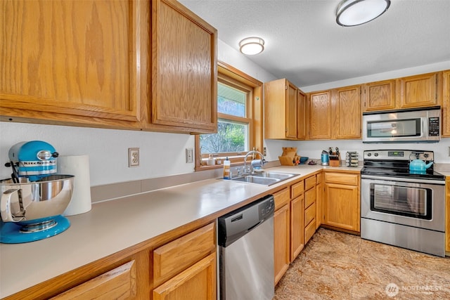 2779 Maple Tree Ln, Camano Island, WA 98282 - kitchen featuring appliances with stainless steel finishes, a sink, light countertops, and a textured ceiling