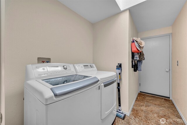 2779 Maple Tree Ln, Camano Island, WA 98282 - laundry room featuring washing machine and clothes dryer, light stone finish floors, and baseboards