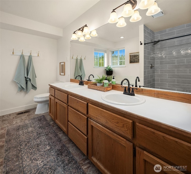 4624 SW 329th Way, Federal Way, WA 98023 - bathroom featuring double vanity, toilet, tiled shower, a chandelier, and baseboards