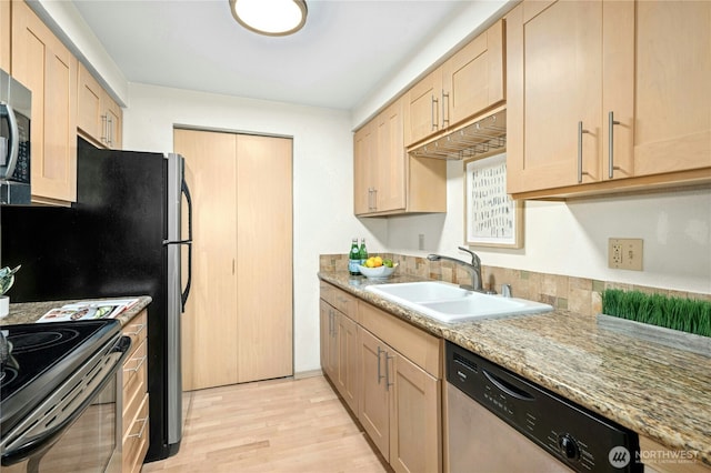 6970 California Ave SW Unit B304, Seattle, WA 98136 - kitchen featuring appliances with stainless steel finishes, light brown cabinets, light wood-style flooring, and light stone counters