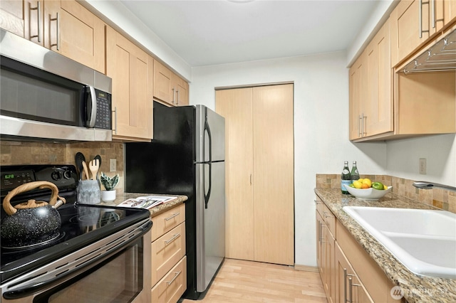 6970 California Ave SW Unit B304, Seattle, WA 98136 - kitchen with stainless steel appliances, light brown cabinets, backsplash, and light wood finished floors