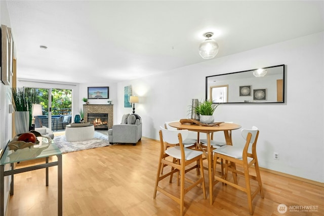 6970 California Ave SW Unit B304, Seattle, WA 98136 - dining room with light wood finished floors and a glass covered fireplace