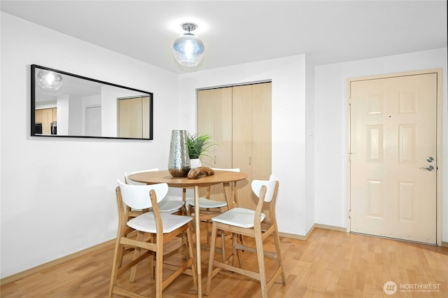 6970 California Ave SW Unit B304, Seattle, WA 98136 - dining area featuring light wood-style flooring and baseboards