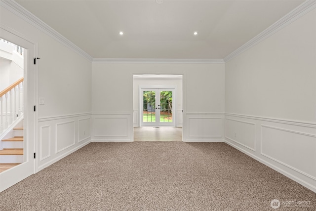 27701 NE 145th Pl, Duvall, WA 98019 - carpeted empty room featuring french doors, crown molding, stairs, wainscoting, and a decorative wall