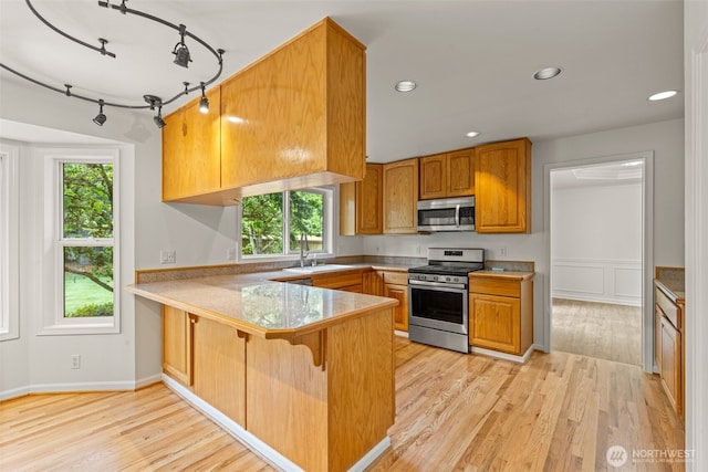 27701 NE 145th Pl, Duvall, WA 98019 - kitchen with appliances with stainless steel finishes, a peninsula, plenty of natural light, light wood-style floors, and recessed lighting