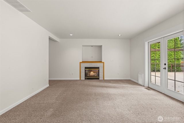 27701 NE 145th Pl, Duvall, WA 98019 - unfurnished living room featuring carpet floors, a tiled fireplace, recessed lighting, and french doors
