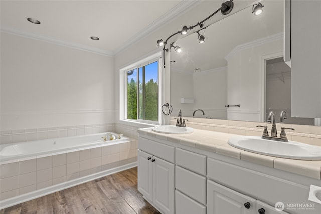 27701 NE 145th Pl, Duvall, WA 98019 - bathroom with double vanity, a garden tub, wood finished floors, and ornamental molding