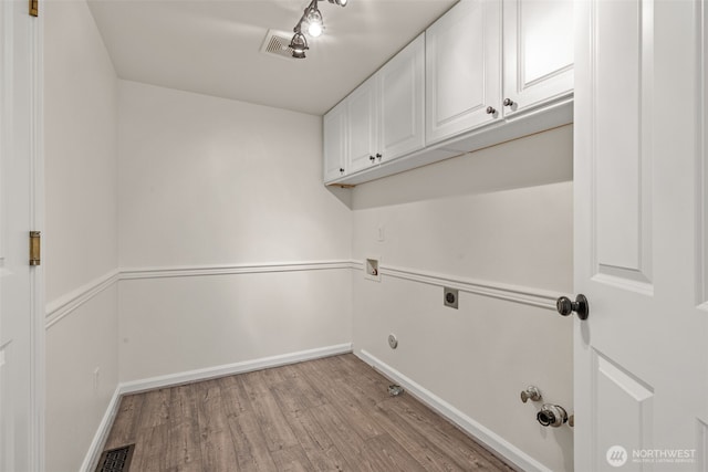 27701 NE 145th Pl, Duvall, WA 98019 - laundry room featuring cabinet space, light wood finished floors, electric dryer hookup, gas dryer hookup, and washer hookup