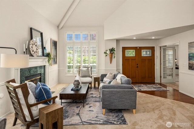 23976 SE 40th Pl, Sammamish, WA 98029 - carpeted living area with high vaulted ceiling, a premium fireplace, beam ceiling, and baseboards