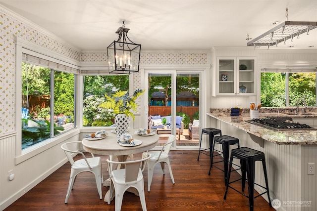 23976 SE 40th Pl, Sammamish, WA 98029 - dining room featuring dark wood-style flooring, crown molding, healthy amount of natural light, and a chandelier