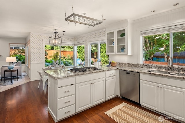 23976 SE 40th Pl, Sammamish, WA 98029 - kitchen with appliances with stainless steel finishes, a sink, white cabinetry, wallpapered walls, and a wainscoted wall