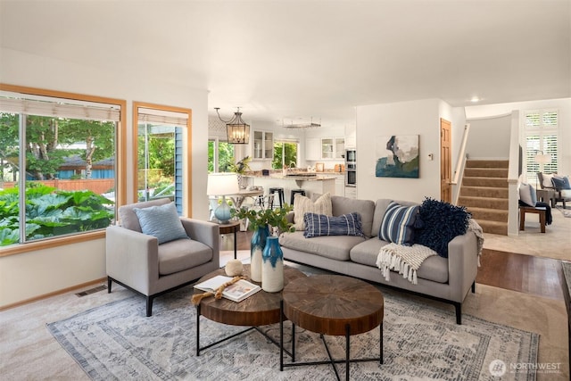 23976 SE 40th Pl, Sammamish, WA 98029 - living area featuring stairway, a chandelier, and baseboards