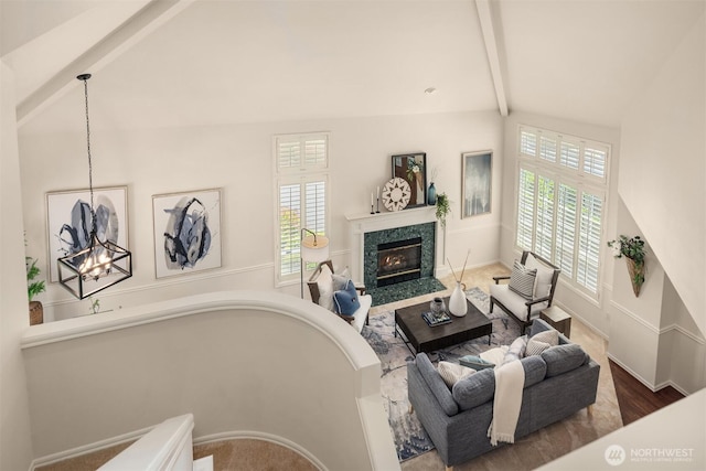 23976 SE 40th Pl, Sammamish, WA 98029 - living area featuring beamed ceiling, a high end fireplace, a chandelier, high vaulted ceiling, and baseboards