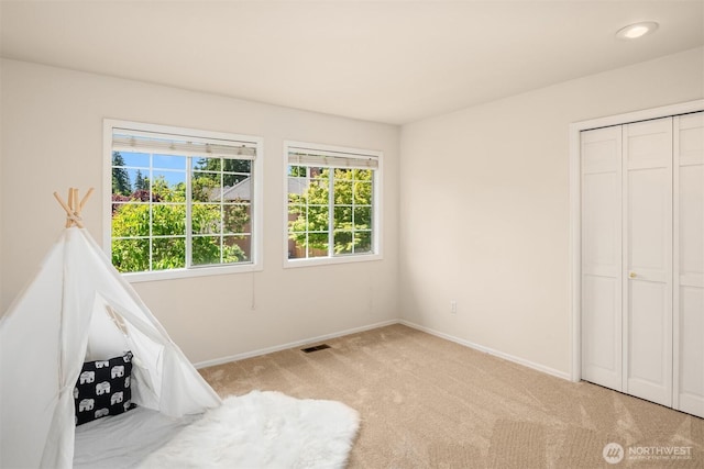 23976 SE 40th Pl, Sammamish, WA 98029 - unfurnished bedroom with multiple windows, carpet floors, baseboards, and a closet