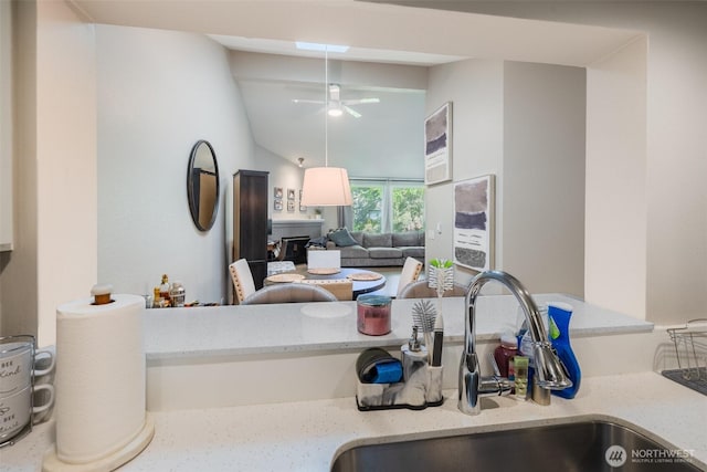 130 SW 116th St Unit F32, Seattle, WA 98146 - kitchen featuring a sink, a ceiling fan, lofted ceiling, and light stone countertops