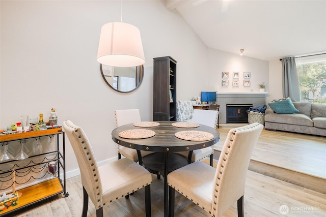 130 SW 116th St Unit F32, Seattle, WA 98146 - dining space featuring wood finished floors, a fireplace, and baseboards
